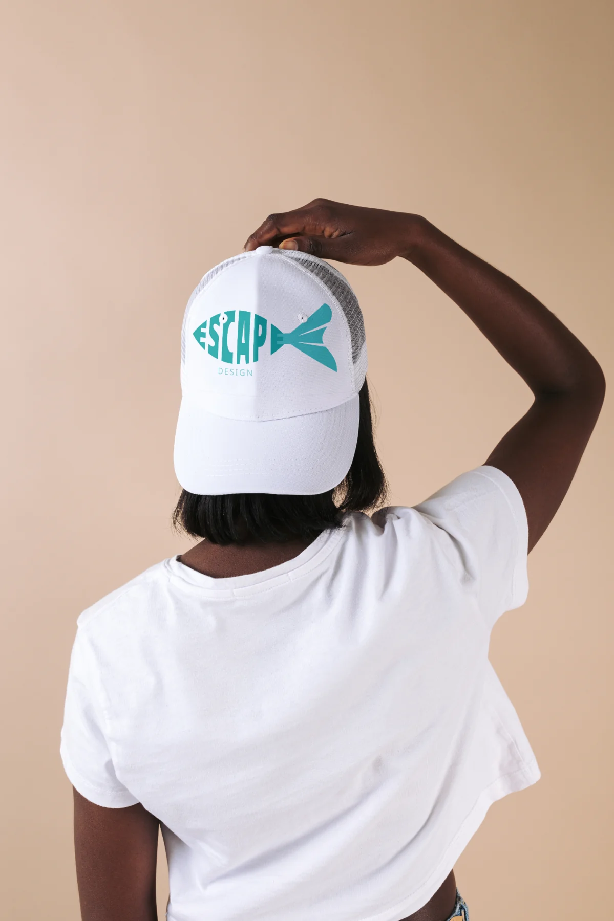 Escape Design fish logo embroidered on a white cap