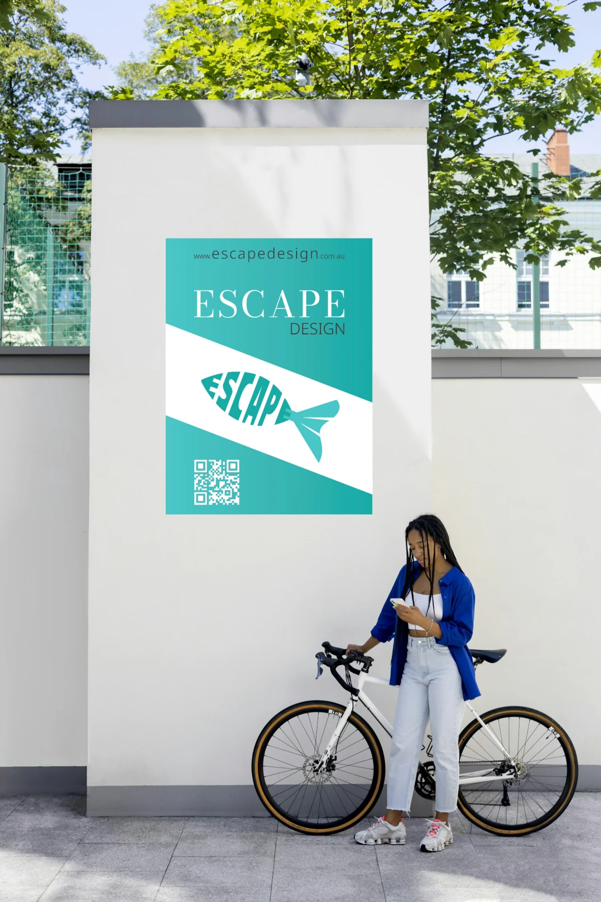 Escape Design promotional poster displayed beside a cyclist