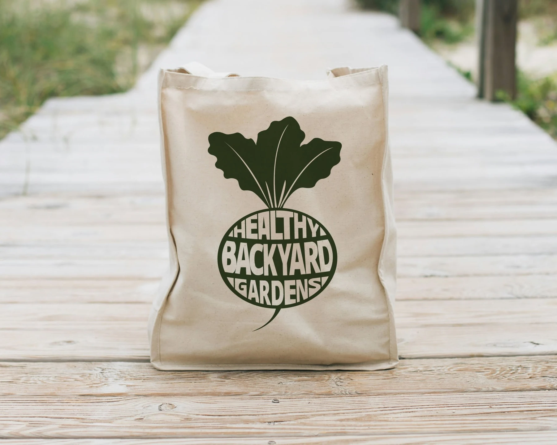 Healthy Backyard Gardens logo on a natural canvas tote bag