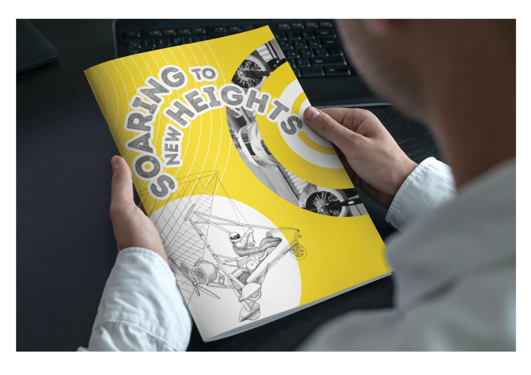 A reader holding the finished Soaring to New Heights aviation magazine